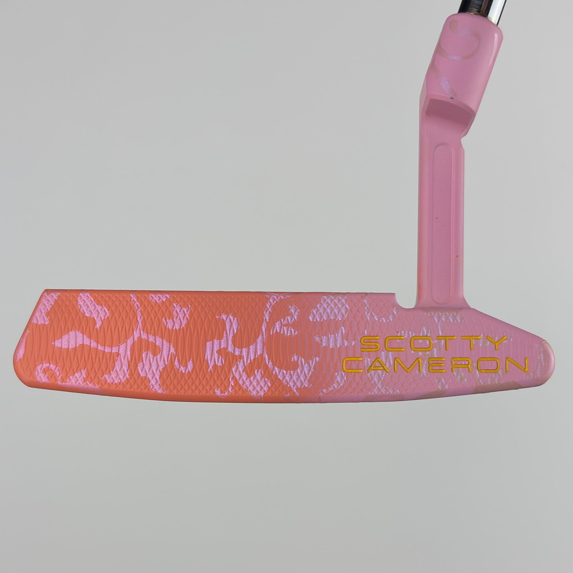 Face-on view of the custom painted Newport 2 Plus, the full blade face in coral and pink floral with the Scotty Cameron stamp at the toe.