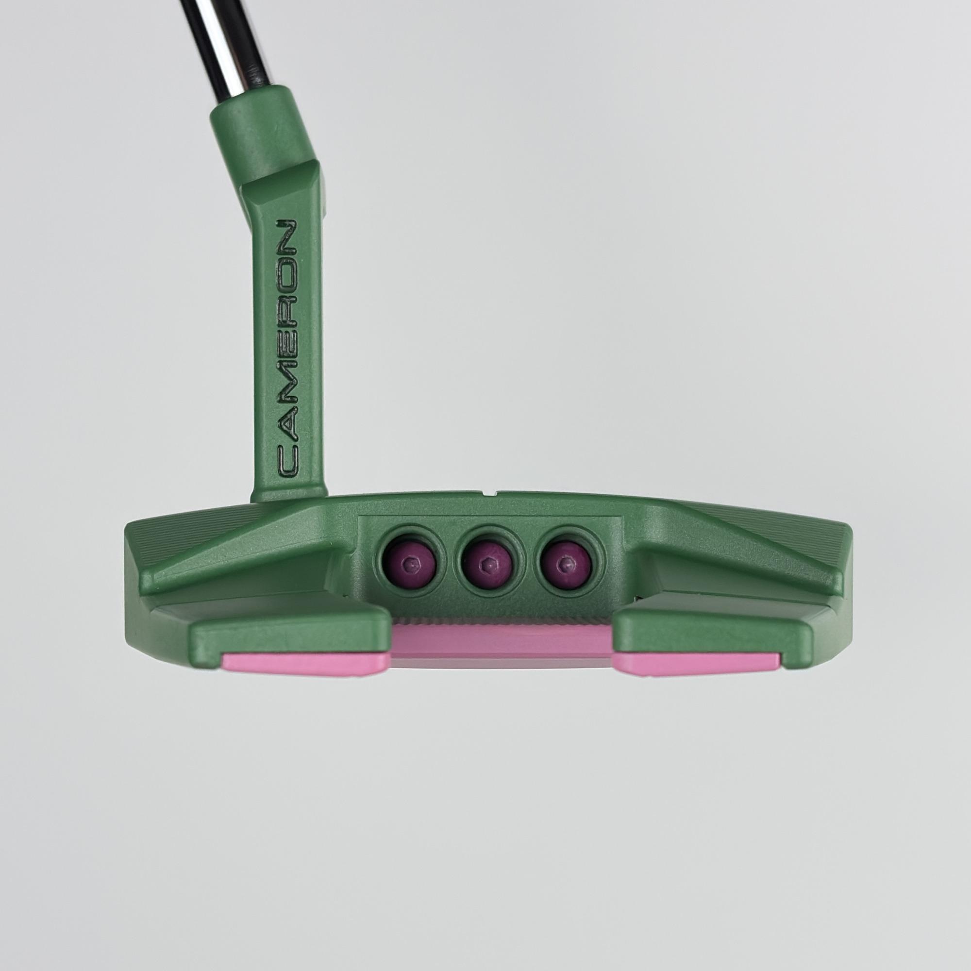 Custom painted Phantom 5.2 at address, green wingback body with pink flange accents and three topline sight dots.